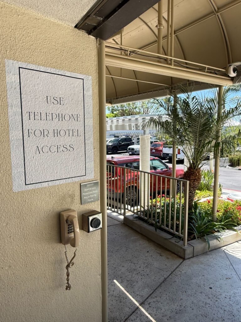 Wayfinding sign grabbing guest's attention towards the hotel telephone.