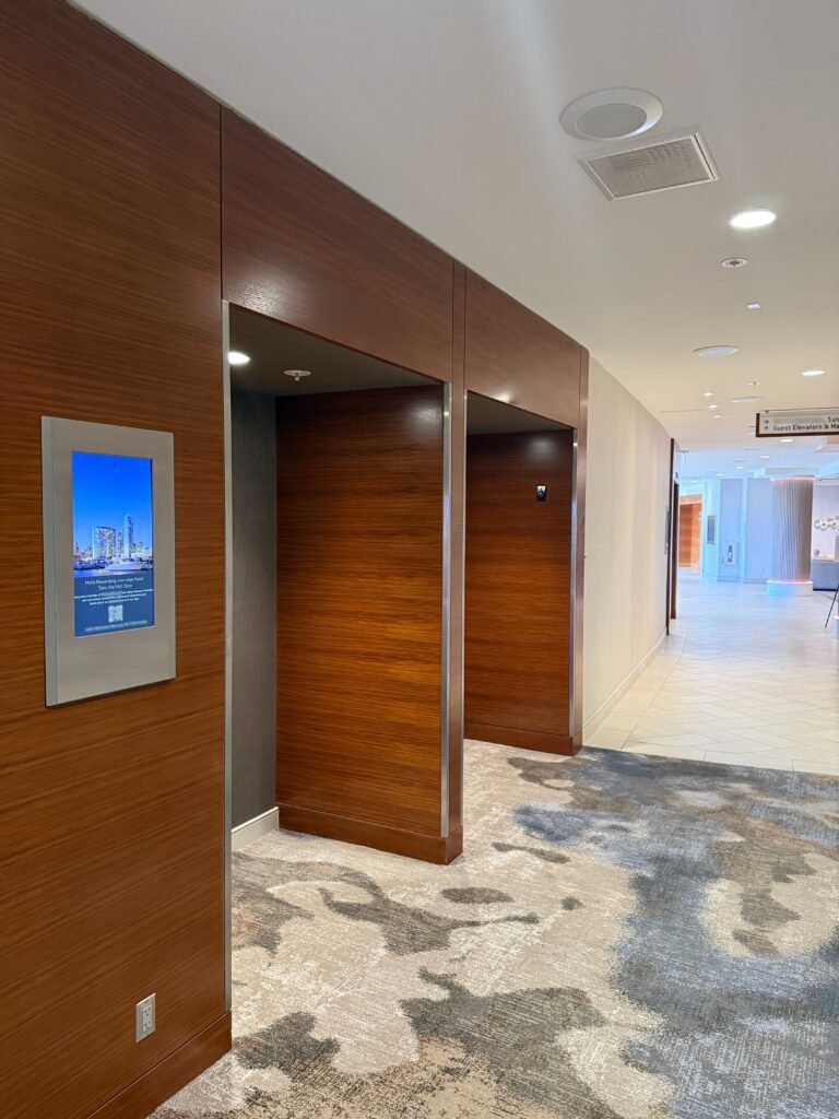 Two meeting rooms containing digital door card signage.